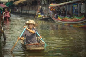 Woman rowing boat at Khlong Lat Mayom Floating Market Bangkok